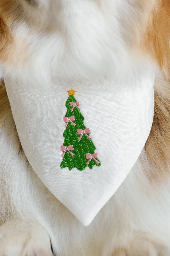 Dog bandana with a Christmas tree design on a fluffy animal.