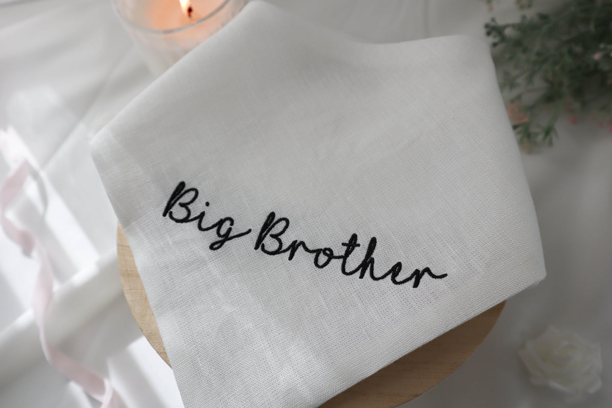 White dog bandana with 'Big Brother' text on a soft background