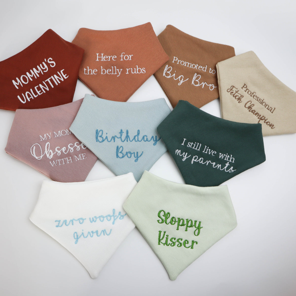 Collection of colorful dog bandanas with humorous text on a white background