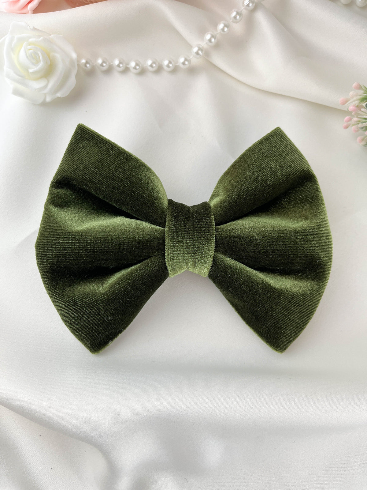 Green bow tie on a white background