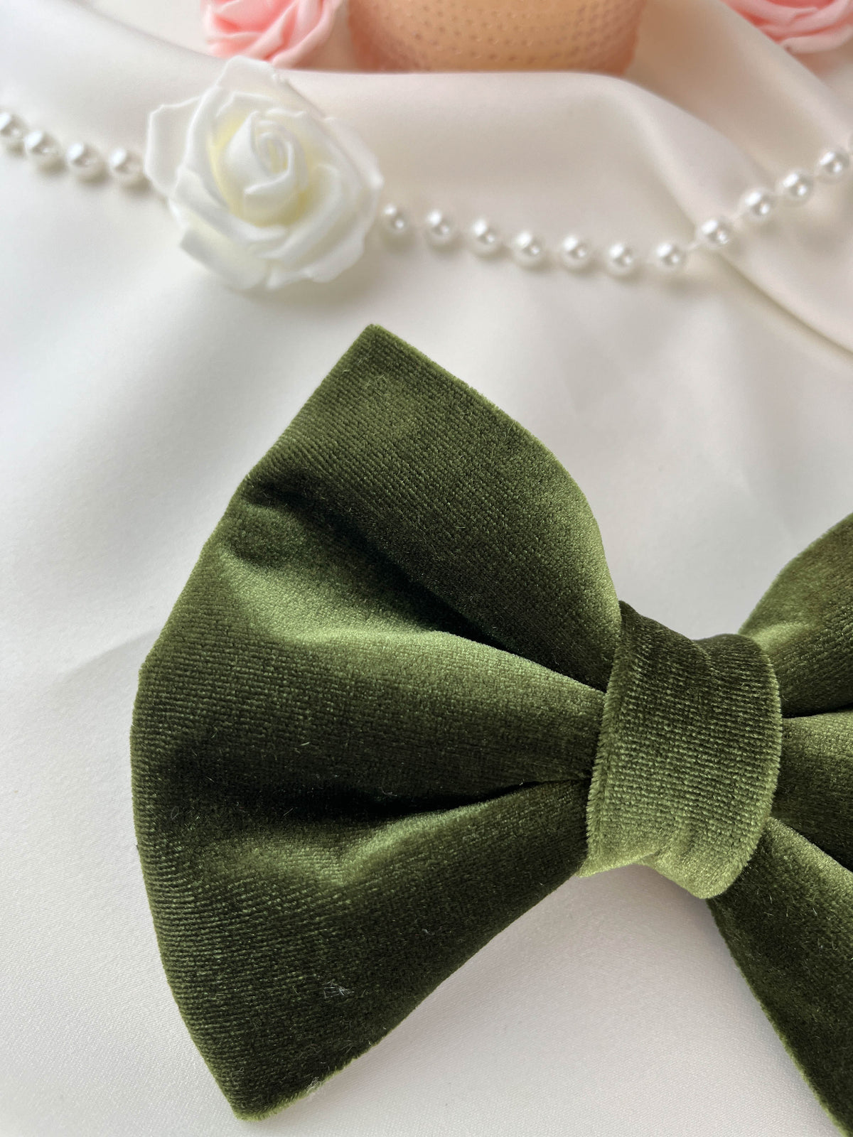 Green velvet bow tie on a white background