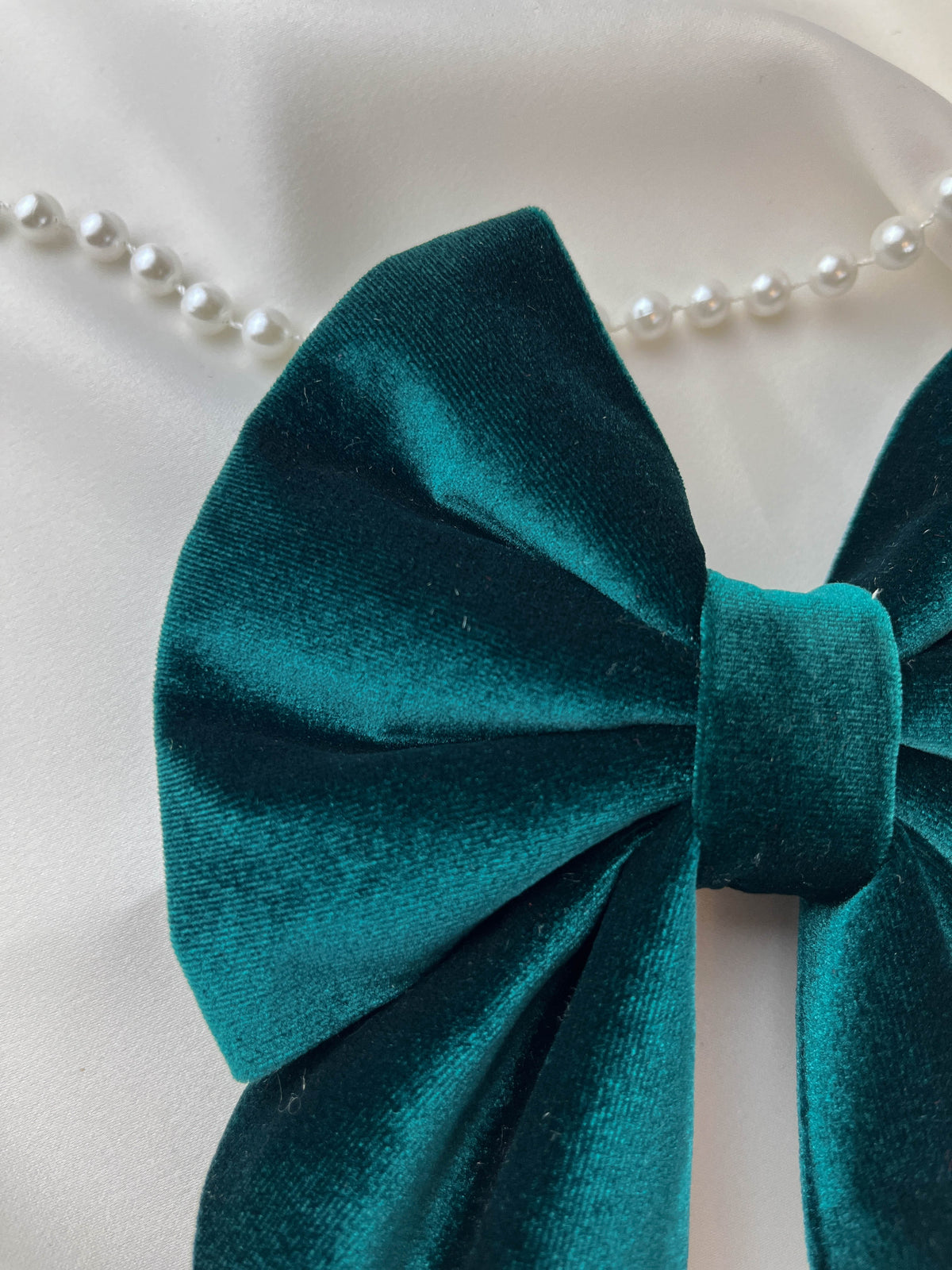 Green velvet bow on a white background