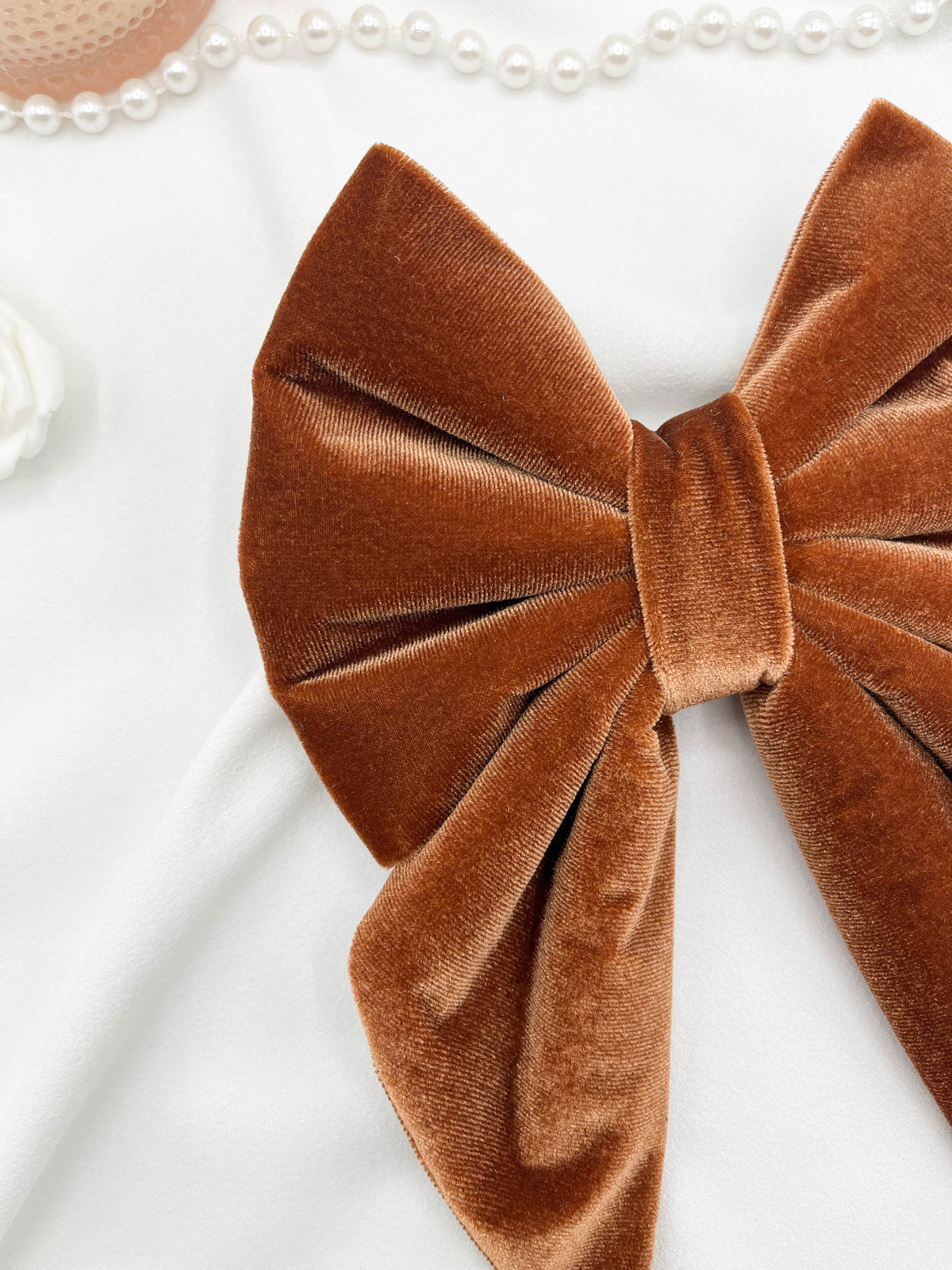Brown velvet bow on a white background