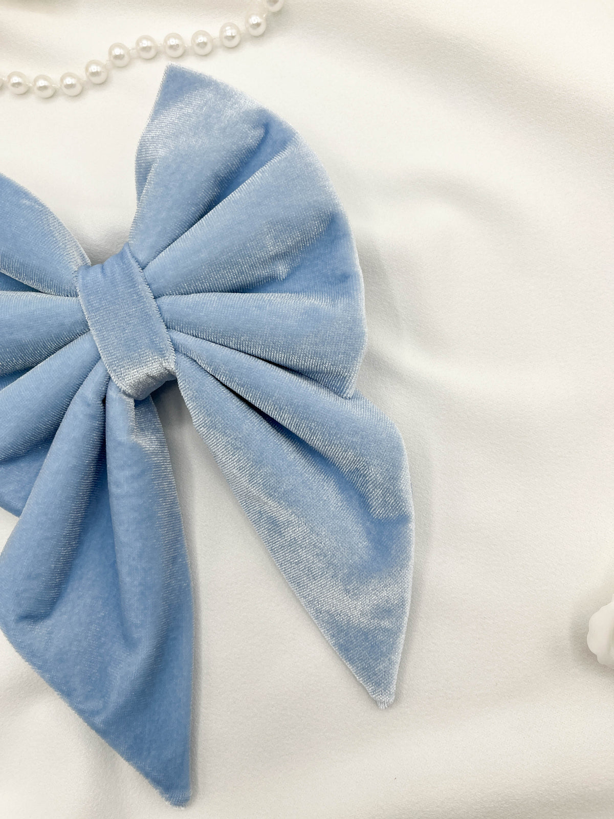 Blue bow hair accessory on a white background