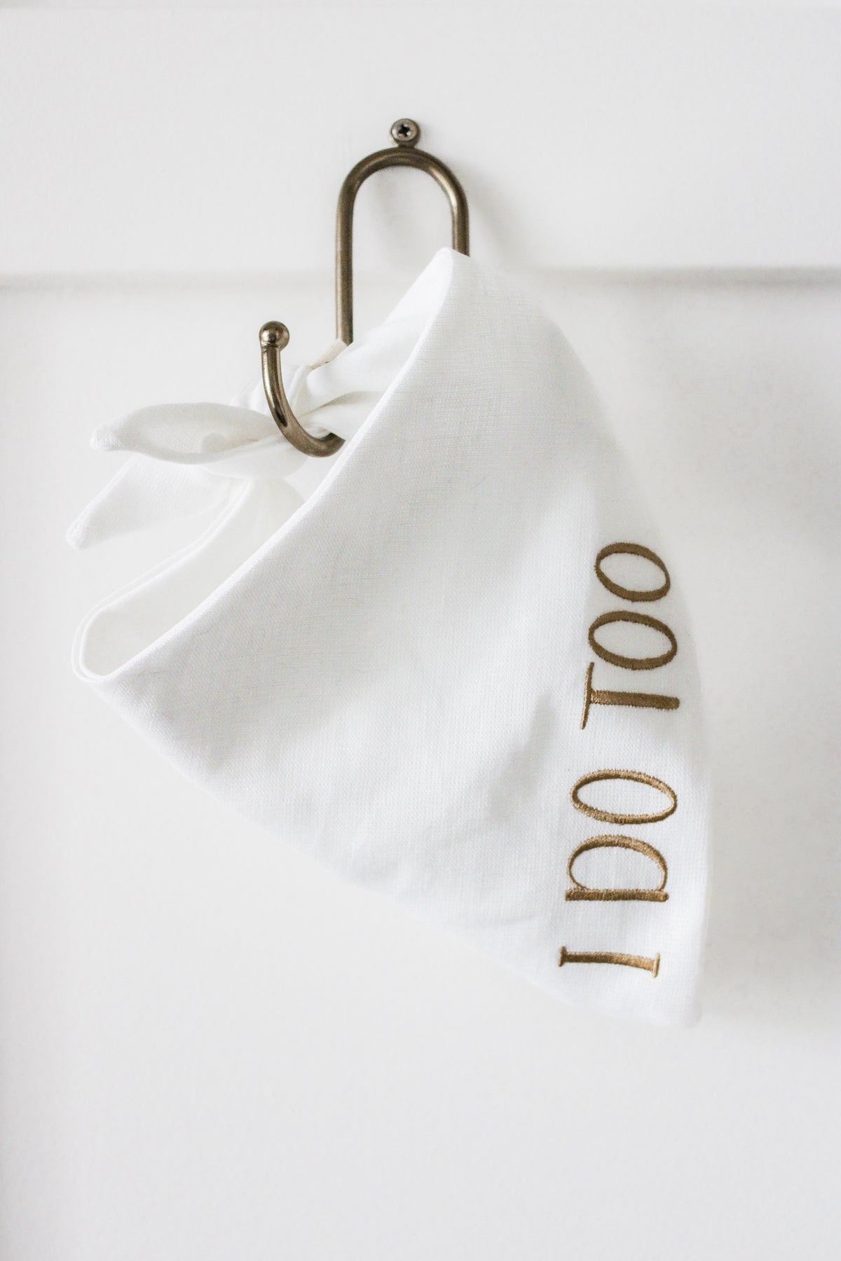 White dog bandana with 'I DO TOO' embroidery on a white background