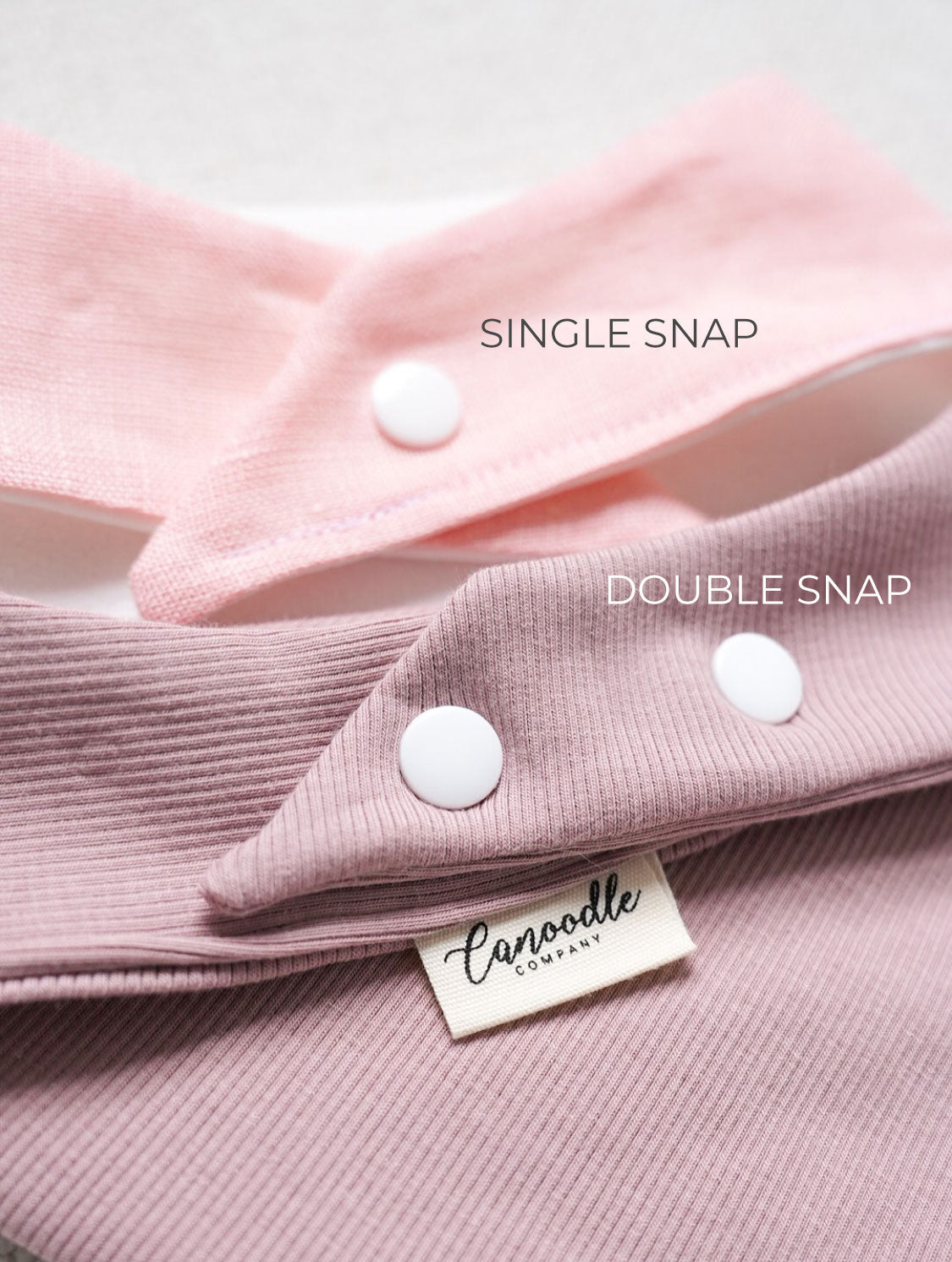 Close-up of pink fabric with single and double snaps labeled, featuring a brand tag.