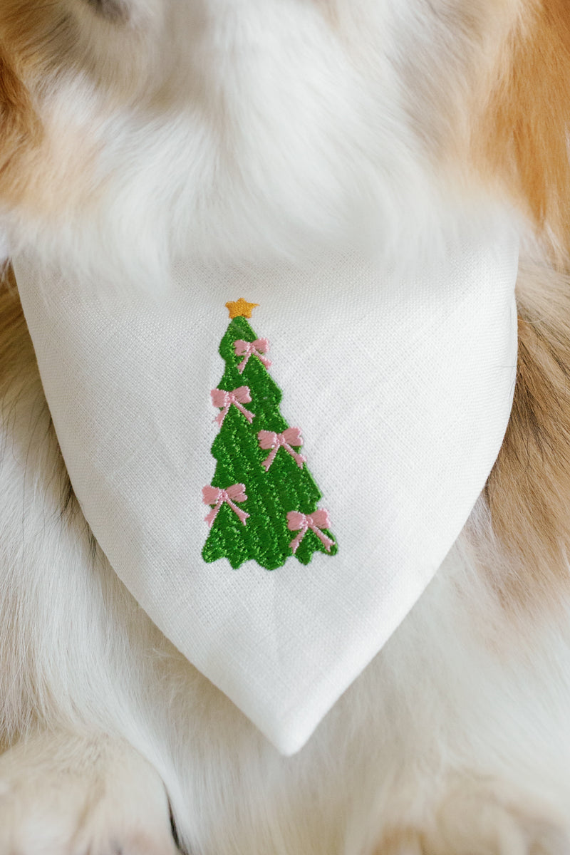Dog bandana with a Christmas tree design on a fluffy animal.