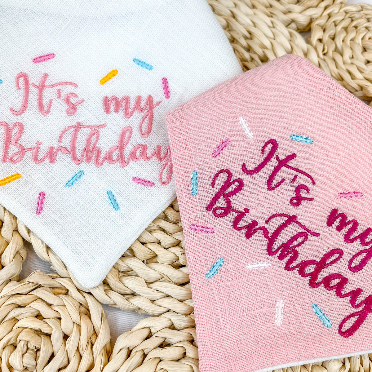 Two dog scarves with 'It's my Birthday' text on a woven surface