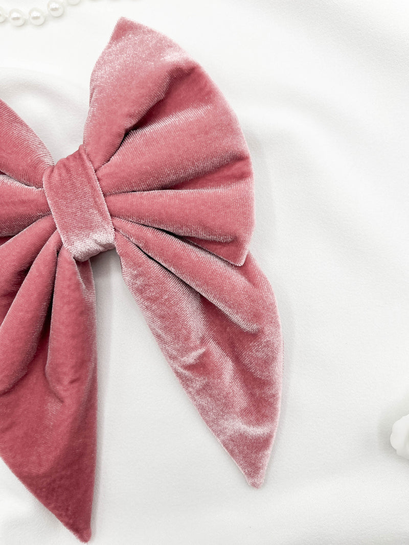 Pink velvet bow on a white background