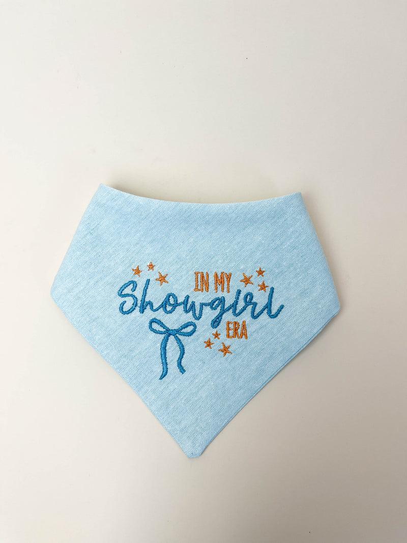 Light blue bandana with embroidered text and stars on a beige background